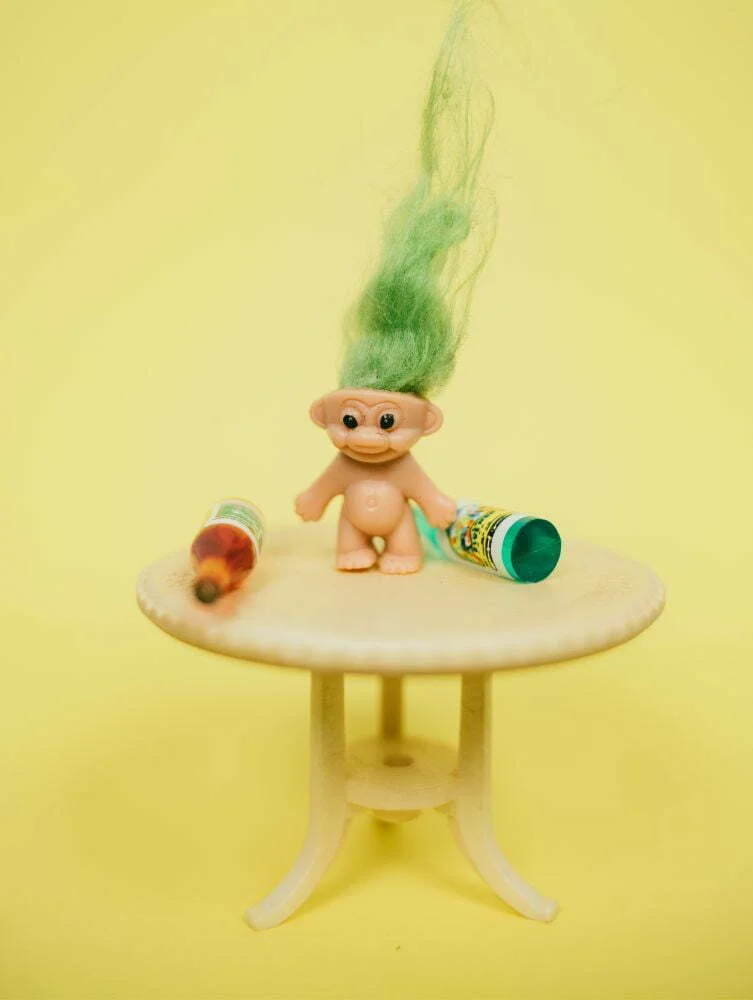 Troll name ideas - A troll toy on a table with bottles