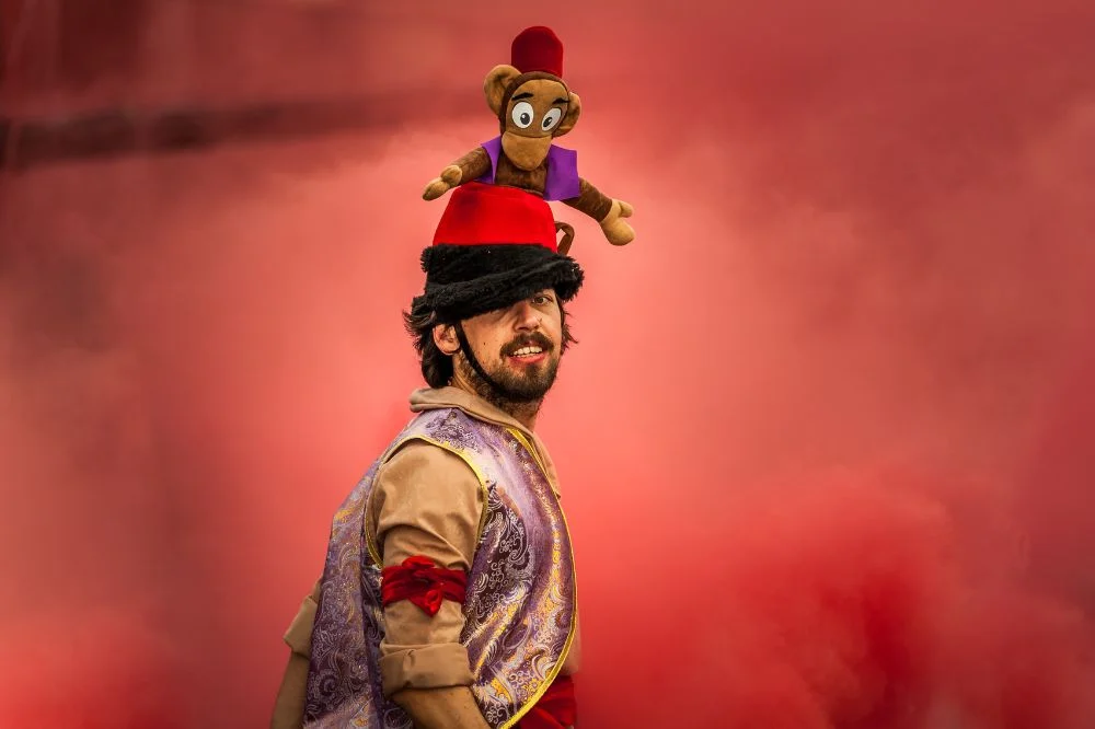 Arabic prince names - A man wearing Aladdin costume on red background