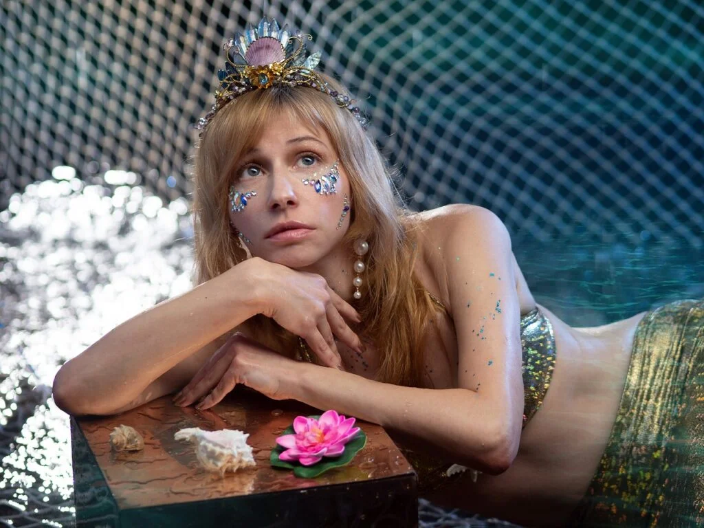 A name for a mermaid -A blonde mermaid posing