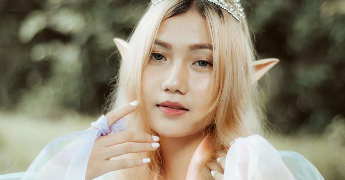 Half elf names - An Asian elf looking at the camera