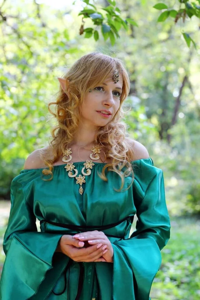 Elf wearing a green dress in the woods