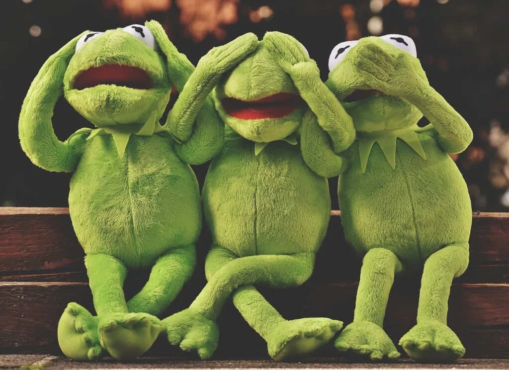 Three Kermit frog plush toys side by side